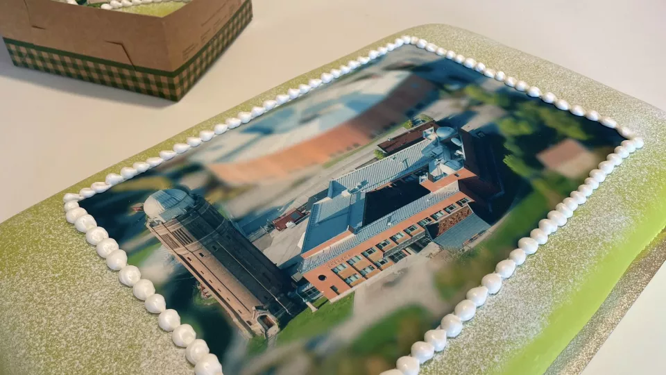 A big cake with a photo of the astronomy building on it. Photo.