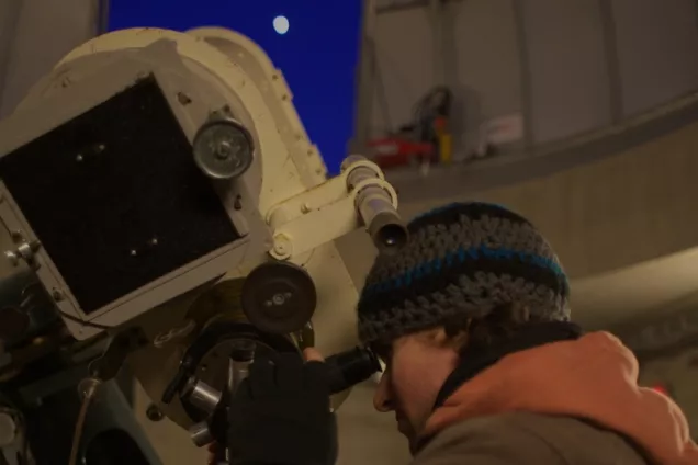 Man looking through a telescope
