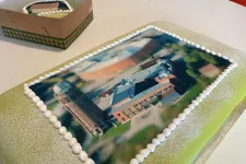 A big cake with a photo of the astronomy building on it. Photo.