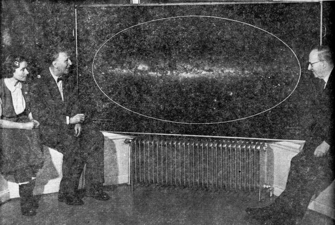 People sitting next to a painting
